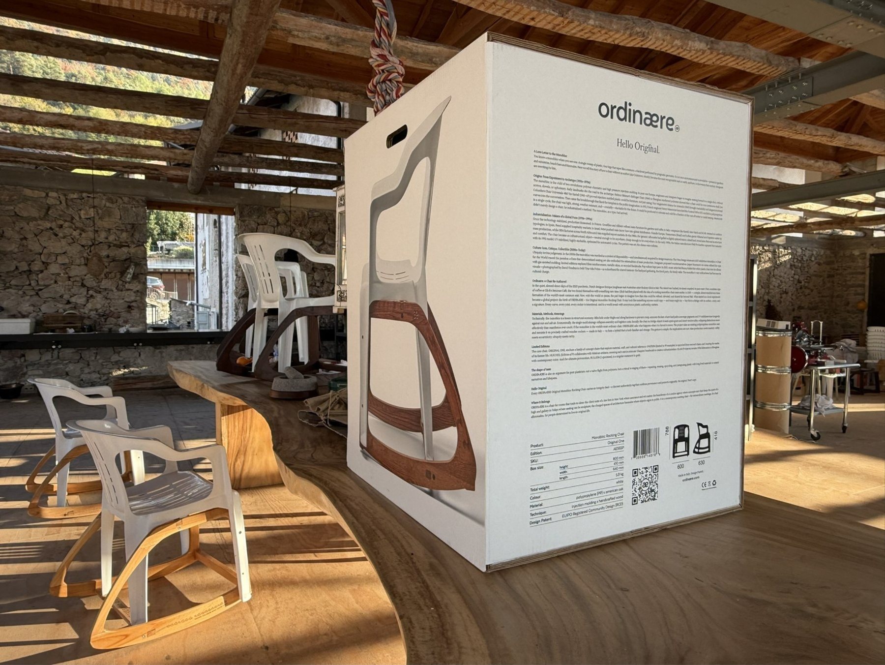 The Monobox: a white box printed with the chair at full size and the love letter, next to two rocking chairs in the workshop