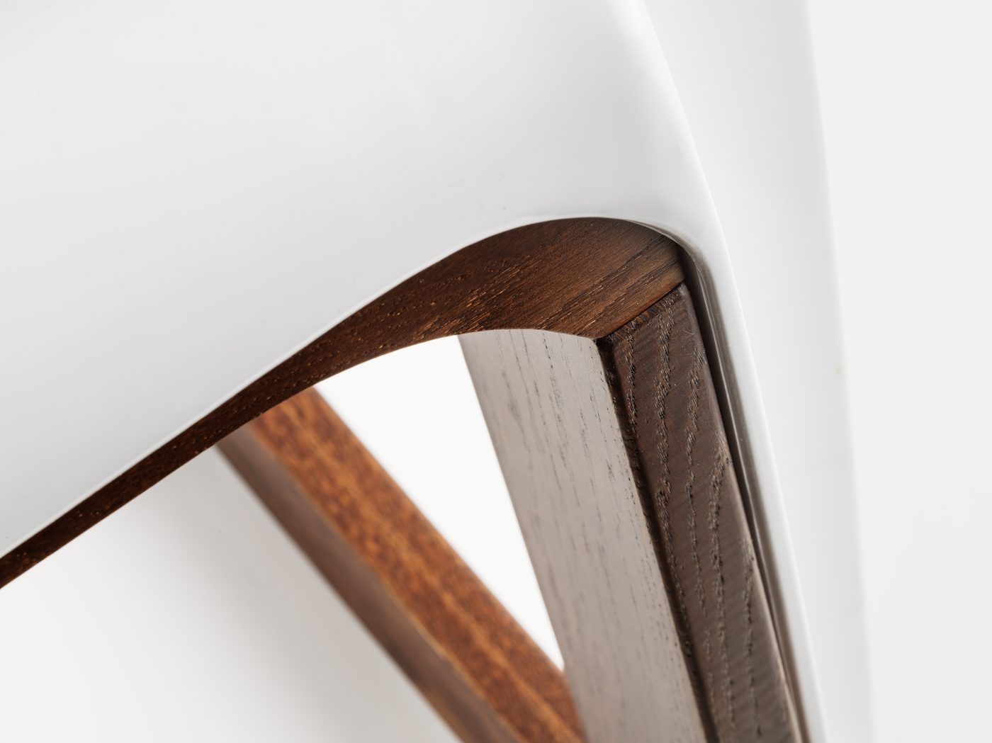 The curve of the oak rocker under the white seat