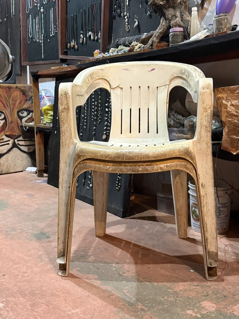 Two cream armchairs stacked in a jewellery workshop